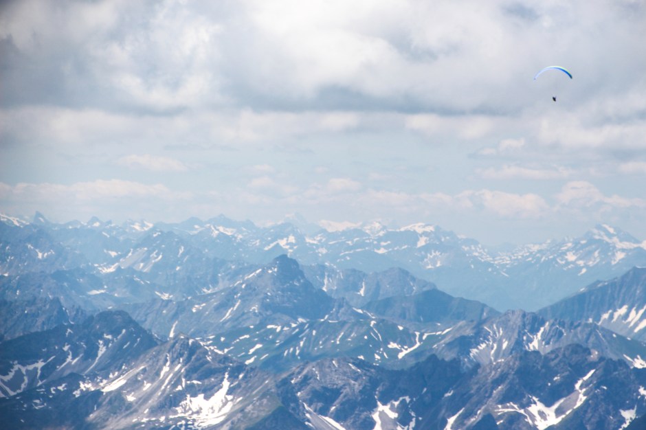 A paraglider skimming over the alps. Bavaria, 2015