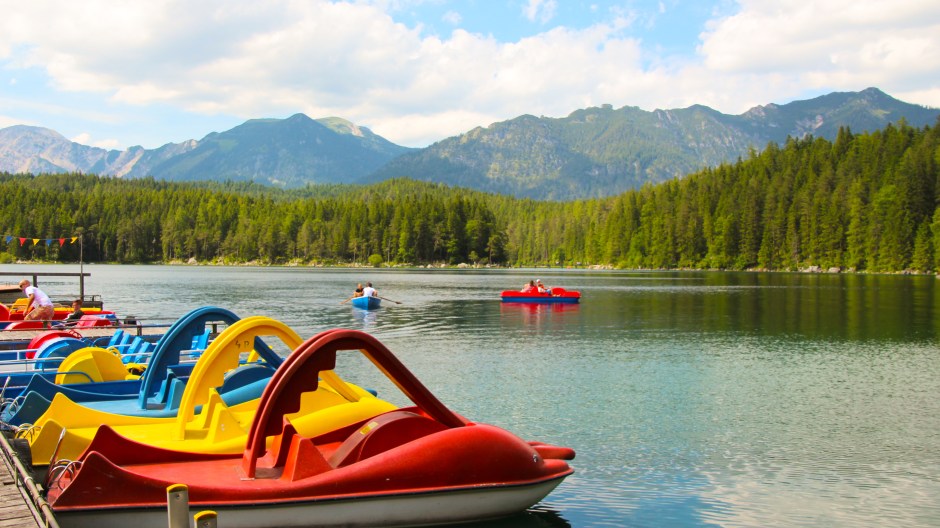 Paddleboats awaiting their passengers on the crystal clear water. Bavaria, 2015