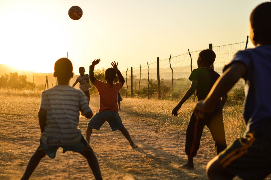 Young boys play football in the dying light. Swaziland, June 2015. 